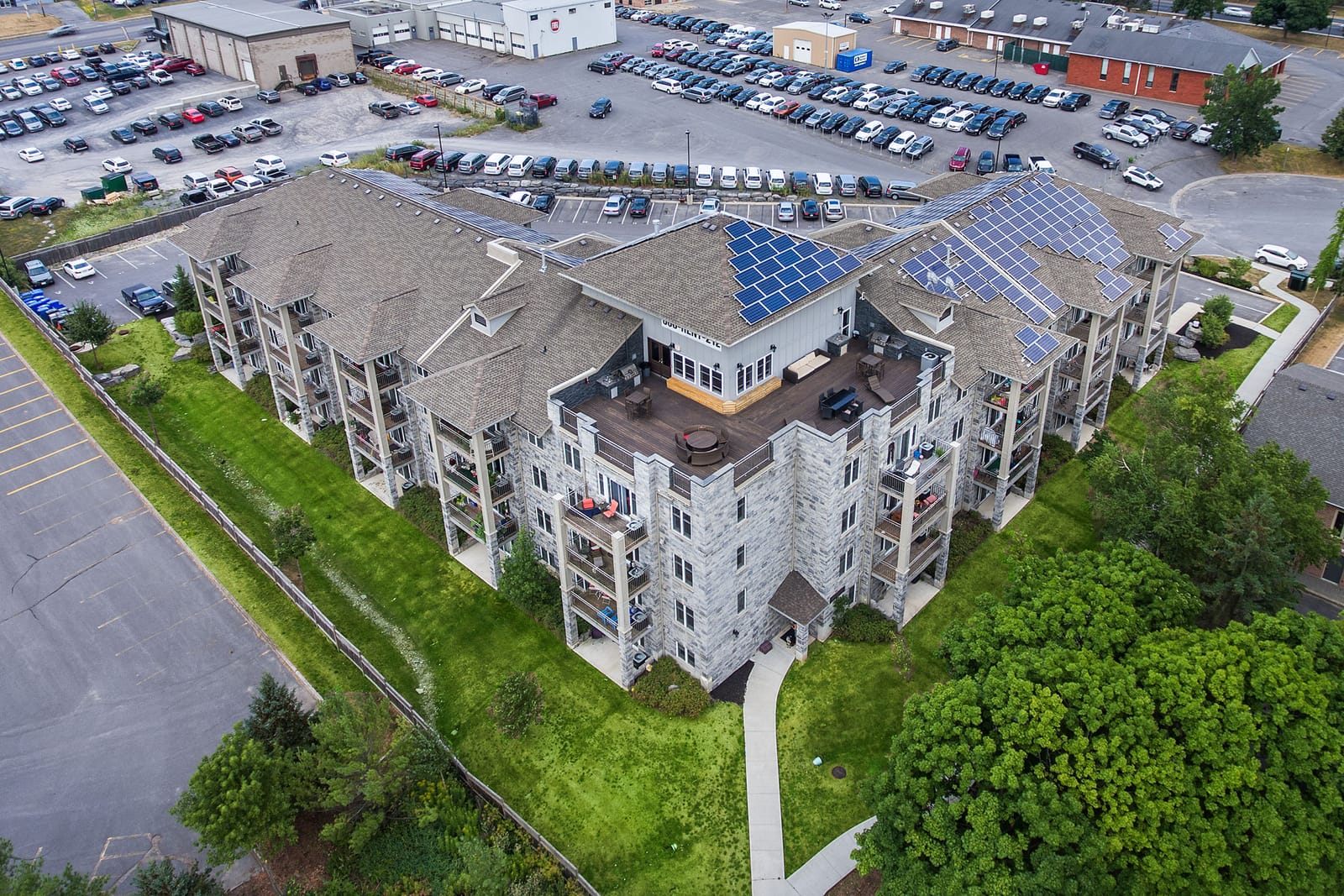 Aerial view of Stonecrest showing the courtyard building, the rooftop terrace and solar panels across the roof