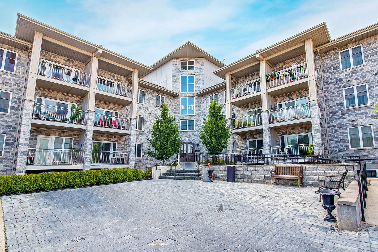 Courtyard entrance at 810 Blackburn Mews, with the paved forecourt and arched front doors