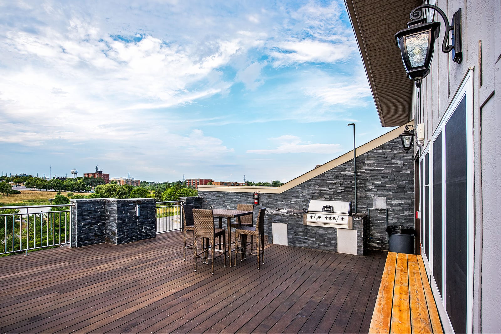 Built-in barbeque and bar-height seating along the rooftop terrace